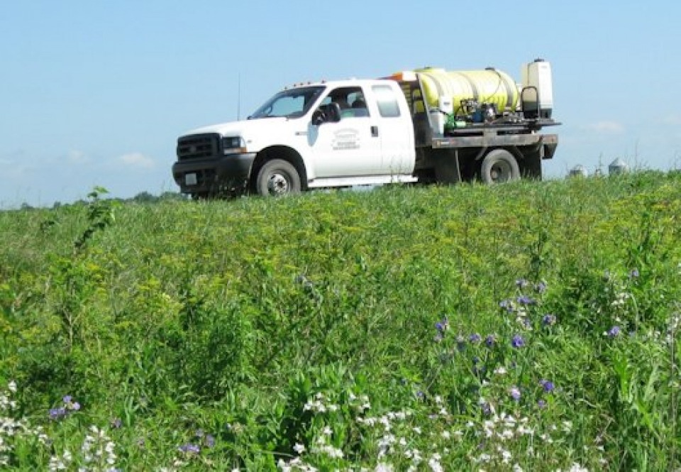 Herbicide truck on the job in a field.